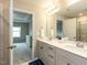Bathroom featuring double vanity, framed mirror, and view into bedroom and glass shower at 730 Firebrick Drive Dr, Cary, NC 27519