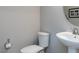 A half-bathroom includes a toilet, a sink, and a mirror at 730 Firebrick Drive Dr, Cary, NC 27519