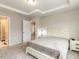 Neutral bedroom featuring a tray ceiling, carpet flooring, and a door to the bathroom at 730 Firebrick Drive Dr, Cary, NC 27519