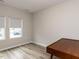 Bedroom featuring wood floors, two large windows, and a corner desk at 730 Firebrick Drive Dr, Cary, NC 27519