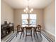 Dining room featuring a dining table with four chairs, a decorative chandelier, and neutral decor at 730 Firebrick Drive Dr, Cary, NC 27519