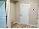 Bright entryway featuring durable laminate flooring and a convenient bench at 730 Firebrick Drive Dr, Cary, NC 27519