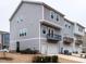 Exterior of the townhouse featuring a two-car garage and a quaint balcony, providing suburban charm at 730 Firebrick Drive Dr, Cary, NC 27519