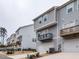Exterior of the townhouse featuring a two-car garage and balconies, blending convenience with modern design at 730 Firebrick Drive Dr, Cary, NC 27519