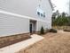 A modern home with gray siding, brick accents, and a well-maintained lawn at 730 Firebrick Drive Dr, Cary, NC 27519