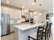 Bright kitchen features gray cabinets, stainless appliances, quartz countertops, and pendant lighting at 730 Firebrick Drive Dr, Cary, NC 27519