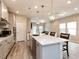 Open concept kitchen features large island, stainless appliances, and view to Gathering room at 730 Firebrick Drive Dr, Cary, NC 27519