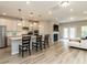 A modern, open-concept kitchen, living, and dining area with lots of light and vinyl floors at 730 Firebrick Drive Dr, Cary, NC 27519
