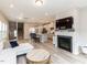 Open-concept living room flowing into a kitchen with hardwood floors and a cozy fireplace at 730 Firebrick Drive Dr, Cary, NC 27519