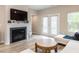 Bright living room featuring a fireplace, television, and a sliding glass door at 730 Firebrick Drive Dr, Cary, NC 27519