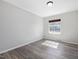 Bright bedroom featuring wood-look flooring, a single window, and neutral paint at 79 John Horton Rd, Apex, NC 27502