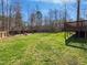 Spacious backyard with a privacy fence and a wooden deck, perfect for outdoor activities at 80 Somerset Dr, Franklinton, NC 27525