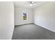 A bright, carpeted bedroom with a ceiling fan and a window at 80 Somerset Dr, Franklinton, NC 27525