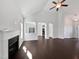 Open-concept living room with fireplace and dark hardwood floors at 80 Somerset Dr, Franklinton, NC 27525