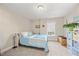 Cozy bedroom featuring carpet, a ceiling light, and a double bed with pastel blue bedding at 8008 Upper Lake Dr, Raleigh, NC 27615