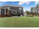 Large backyard features lush lawn, screened-in porch, and mature trees for privacy at 8201 Southmoor Hill Trl, Wake Forest, NC 27587