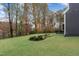 Backyard with manicured lawn, mature trees and tasteful landscaping in a garden bed at 8201 Southmoor Hill Trl, Wake Forest, NC 27587