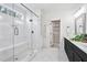 Bright bathroom featuring a glass shower, walk-in closet, and a double-sink vanity at 8201 Southmoor Hill Trl, Wake Forest, NC 27587