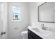 Bright bathroom featuring a sink, a square mirror, neutral paint, and natural light at 8201 Southmoor Hill Trl, Wake Forest, NC 27587