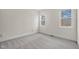 Neutral bedroom featuring soft carpeting and two windows that fill the space with natural light at 8201 Southmoor Hill Trl, Wake Forest, NC 27587