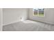 Carpeted bedroom showcasing a window with natural lighting and neutral paint at 8201 Southmoor Hill Trl, Wake Forest, NC 27587
