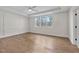 Spacious bedroom with hardwood floors, paneled walls, and a large window at 8201 Southmoor Hill Trl, Wake Forest, NC 27587