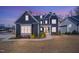 Beautiful two-story home featuring a dark blue exterior and a well-manicured front yard at 8201 Southmoor Hill Trl, Wake Forest, NC 27587