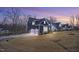 Beautiful new construction with a two car garage and a manicured lawn at sunset at 8201 Southmoor Hill Trl, Wake Forest, NC 27587