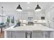 Bright kitchen boasts a large island with quartz countertops and stainless steel appliances at 8201 Southmoor Hill Trl, Wake Forest, NC 27587