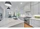 Bright and airy kitchen featuring a large island with a sink and modern appliances at 8201 Southmoor Hill Trl, Wake Forest, NC 27587