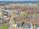 Aerial view of homes with modern exteriors nestled amongst a wooded landscape in a quiet community at 8201 Southmoor Hill Trl, Wake Forest, NC 27587