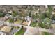 Aerial view showcasing a neighborhood with mature trees, well-manicured lawns, and homes with varied architectural styles at 909 Lake Boone Trl, Raleigh, NC 27607