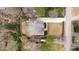 An aerial perspective showcasing a home with a spacious lawn, a private driveway, and surrounding mature trees at 909 Lake Boone Trl, Raleigh, NC 27607