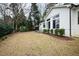 Spacious backyard featuring a well-maintained lawn, patio area, and the exterior of a charming white home at 909 Lake Boone Trl, Raleigh, NC 27607