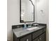 Well-lit bathroom with a sleek vanity, dark cabinets, and a decorative mirror providing modern elegance at 909 Lake Boone Trl, Raleigh, NC 27607