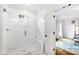Modern bathroom featuring a glass-enclosed shower with white subway tile and a built-in bench, adjacent to a bedroom at 909 Lake Boone Trl, Raleigh, NC 27607