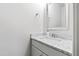 Modern half bathroom featuring a sleek vanity with marble countertop and silver framed mirror at 909 Lake Boone Trl, Raleigh, NC 27607