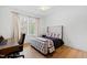 Comfortable bedroom with hardwood floors, upholstered bed frame, and bright windows, creating a serene retreat at 909 Lake Boone Trl, Raleigh, NC 27607