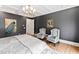 This primary bedroom has a tray ceiling, sitting area and chic wall art at 909 Lake Boone Trl, Raleigh, NC 27607