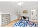 Well-lit bedroom with hardwood floors, desk, dresser, and comfortable quilt bedding, offering a cozy and functional space at 909 Lake Boone Trl, Raleigh, NC 27607