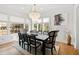 Dining room featuring natural light, modern chandelier, seating for eight, and stylish decor at 909 Lake Boone Trl, Raleigh, NC 27607