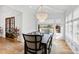 Dining room featuring natural light, modern chandelier, seating for eight, and stylish decor at 909 Lake Boone Trl, Raleigh, NC 27607