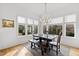 Well-lit dining room with large windows, hardwood floors, and a dark wood dining table at 909 Lake Boone Trl, Raleigh, NC 27607