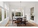 Bright dining room with a large window, hardwood floors, and a modern chandelier at 909 Lake Boone Trl, Raleigh, NC 27607