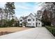 Stunning two-story home with a white exterior, black-framed windows, and beautifully landscaped front yard at 909 Lake Boone Trl, Raleigh, NC 27607