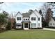 Elegant white two-story home featuring a manicured lawn and classic architectural details, offering timeless curb appeal at 909 Lake Boone Trl, Raleigh, NC 27607
