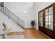 Bright foyer features hardwood floors, staircase with decorative railing, and an elegant paneled wall at 909 Lake Boone Trl, Raleigh, NC 27607