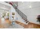 Bright foyer features hardwood floors, staircase with decorative railing, and an elegant paneled wall at 909 Lake Boone Trl, Raleigh, NC 27607