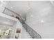 Bright foyer features hardwood floors, staircase with decorative railing, and an elegant paneled wall at 909 Lake Boone Trl, Raleigh, NC 27607