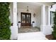 Inviting front entrance featuring double doors, elegant lighting, and classic architectural details at 909 Lake Boone Trl, Raleigh, NC 27607